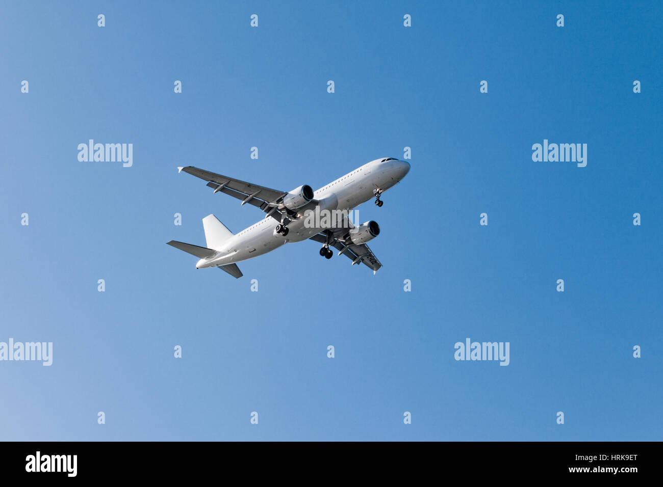 white airplane on a blue background. airplane in the sky Stock Photo ...