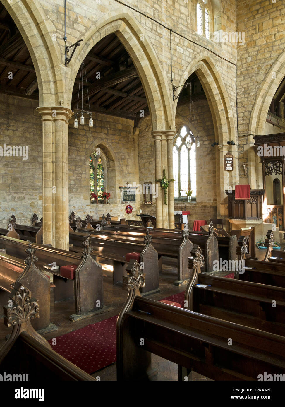 Gothic arches, stone pillars and pews inside, All Saints Church, Hoby, Leicestershire, England, UK Stock Photo