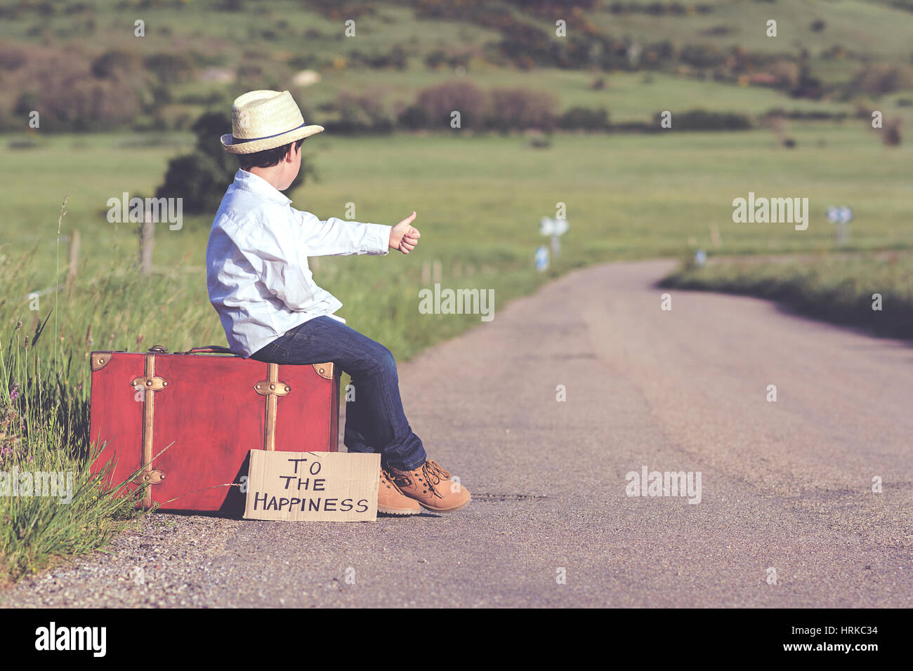 Boy with suitcase on the road Stock Photo Alamy
