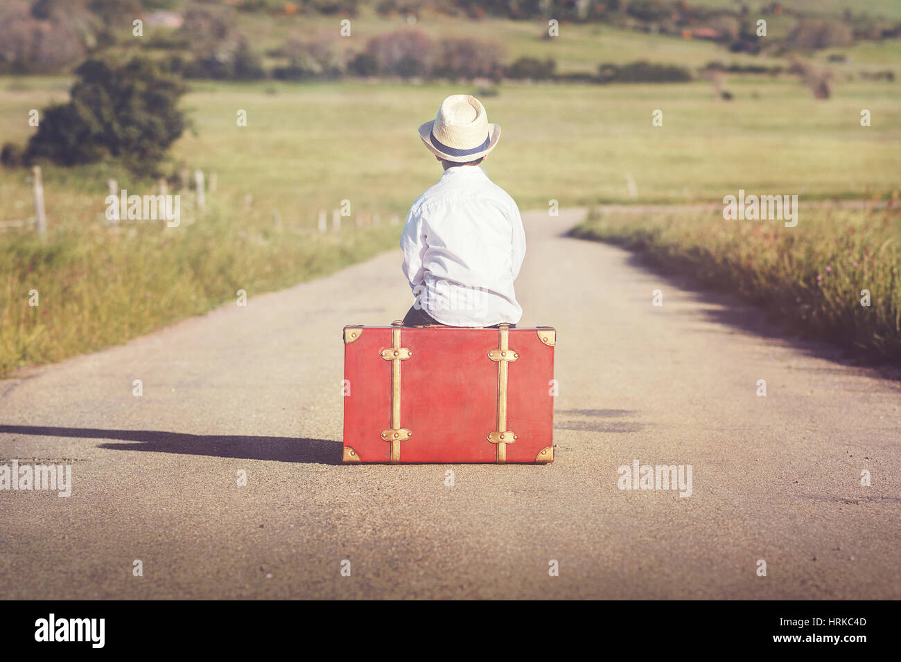 Boy with suitcase on the road Stock Photo Alamy