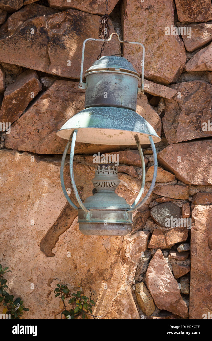 Old Antique Oil Lantern Hanging on a Stone Wall Stock Photo - Alamy