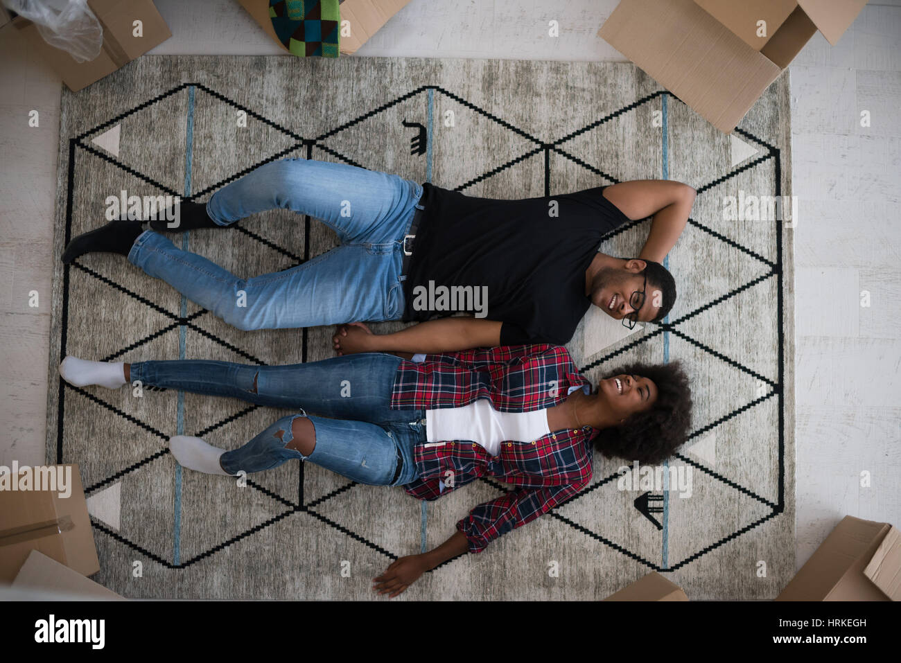 Top view of attractive young African American couple moving, holding ...