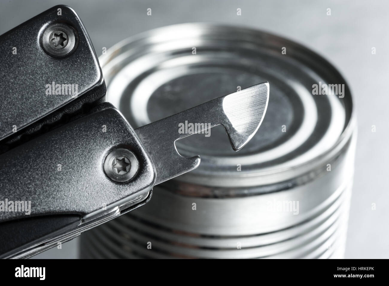 opening the tin with tin opener (can opener Stock Photo Alamy