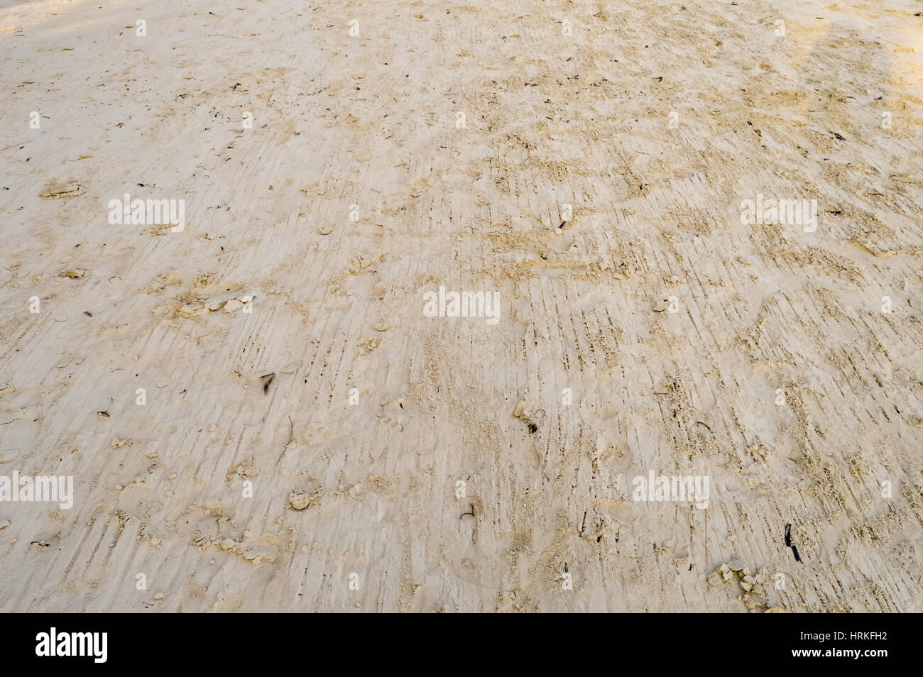 Smooth yellow beach sand with rake with sun rays Stock Photo - Alamy