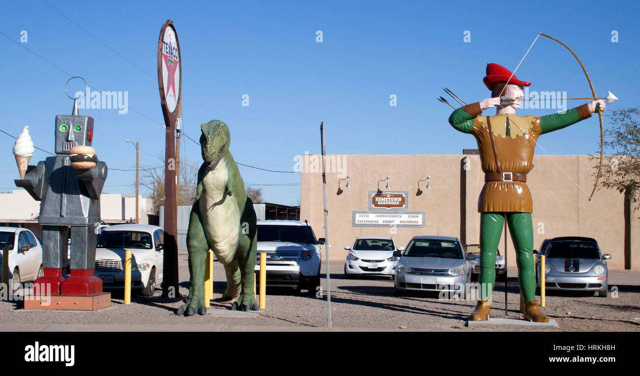 In Hatch, New Mexico, a robot with ice cream and a burger stands with a dinosaur and Robin Hood, creating a wild roadside restaurant scene. Stock Photo