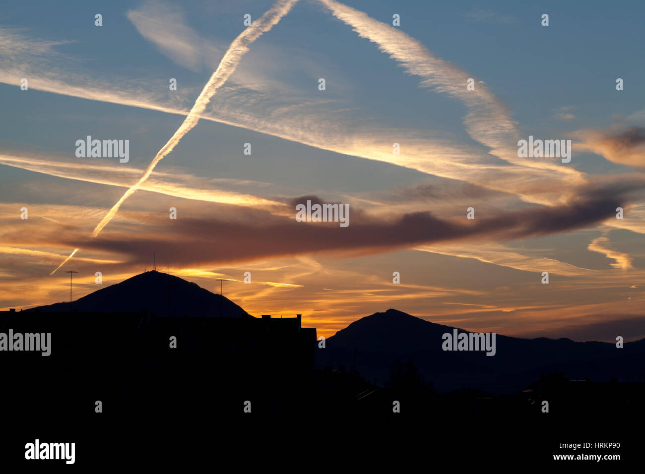 sky chemical trails on the sunset Stock Photo
