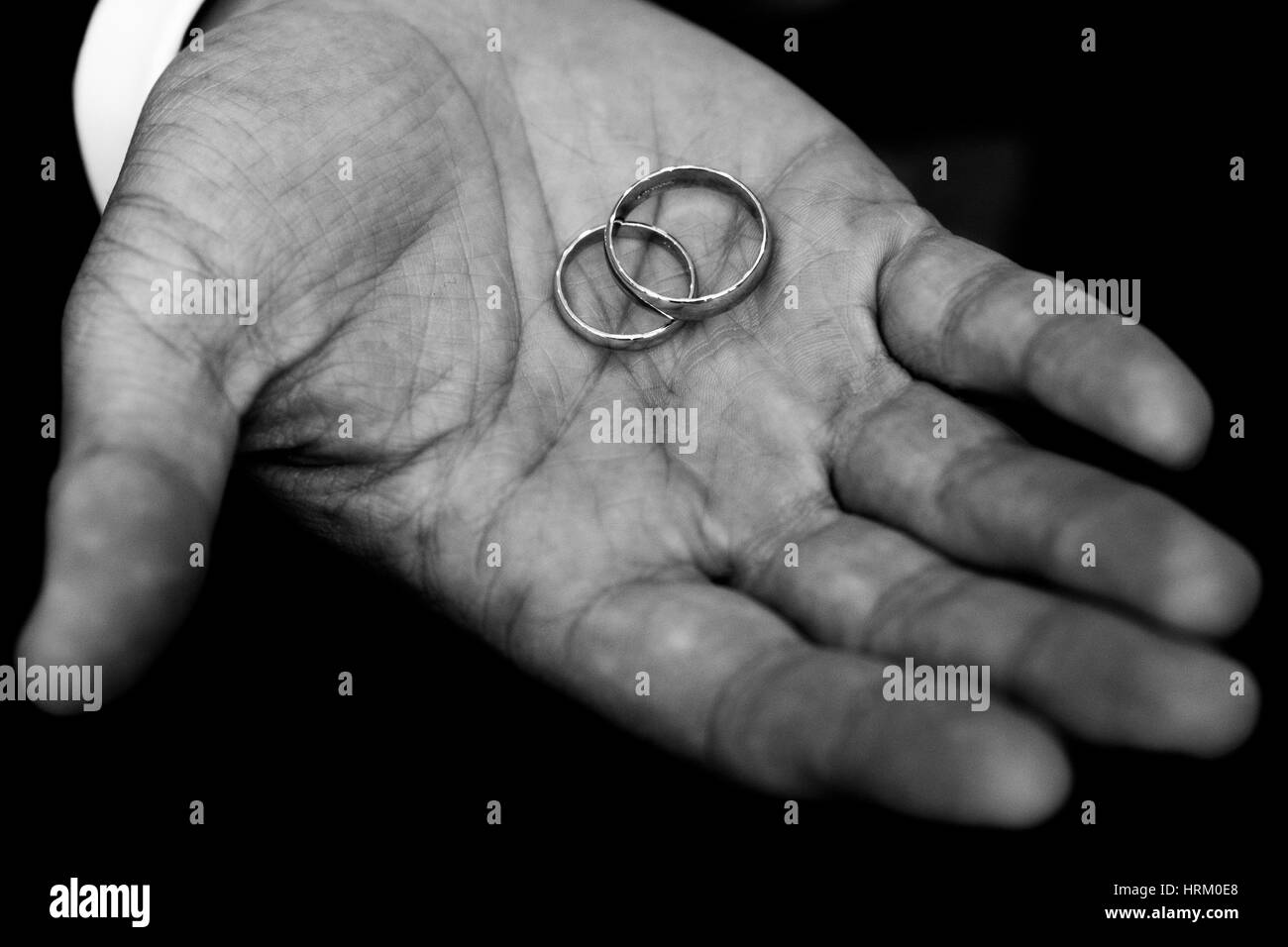 Wedding rings held by the groom Stock Photo