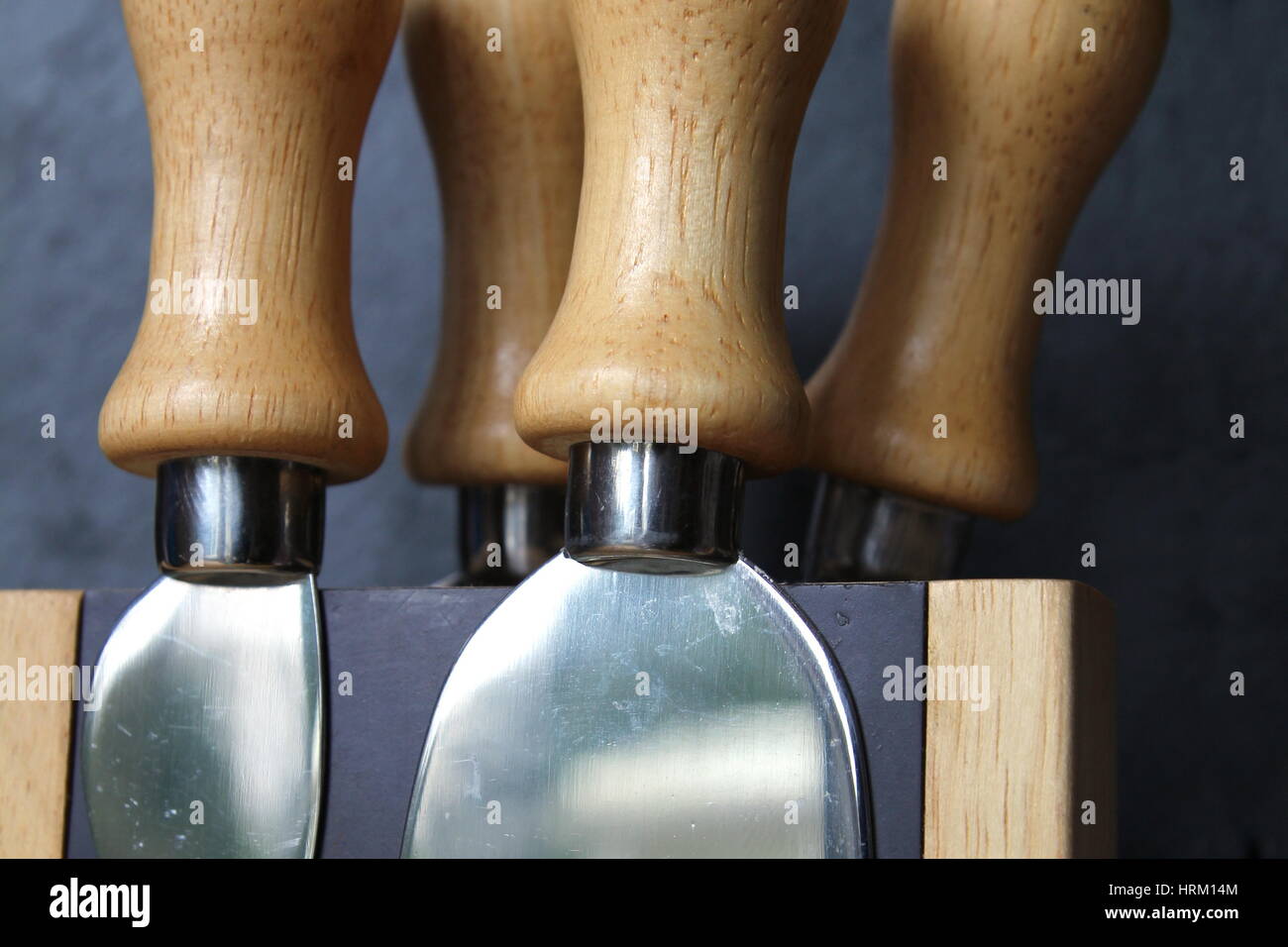 Four beech wood handle cheese knives on block Stock Photo Alamy