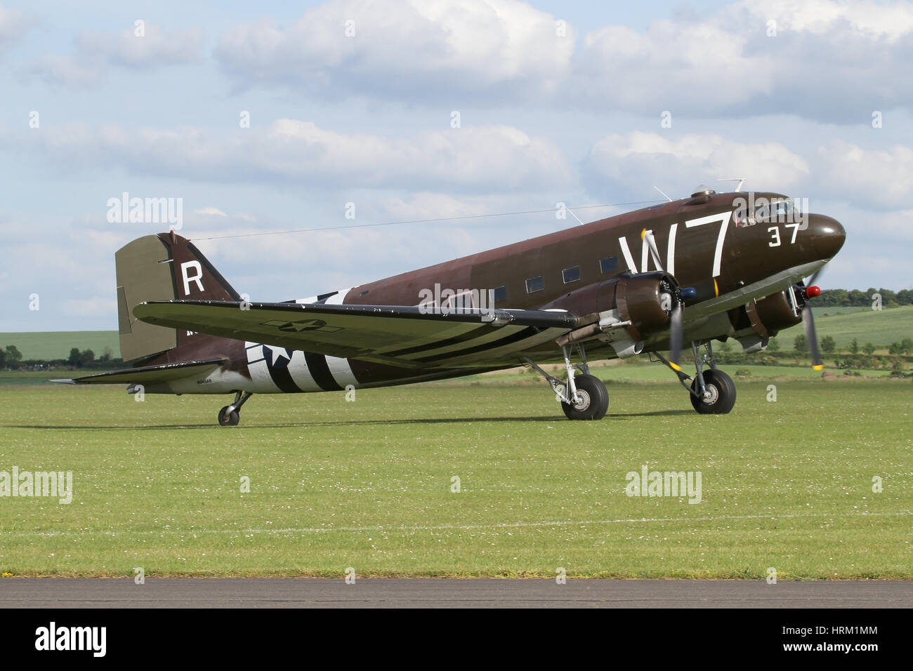 US based Douglas DC-3 landing at the D-Day anniversary airshow at Duxford in 2014. Duxford hosted a rare gathering of DC-3/C-47s for the event. Stock Photo