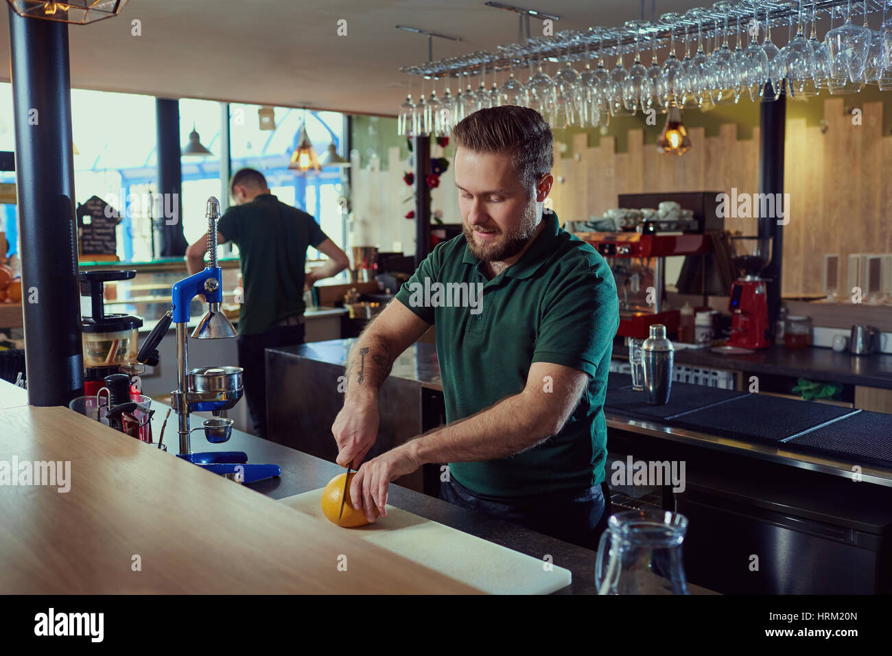 The barman prepares fresh juice at bar.  Stock Photo