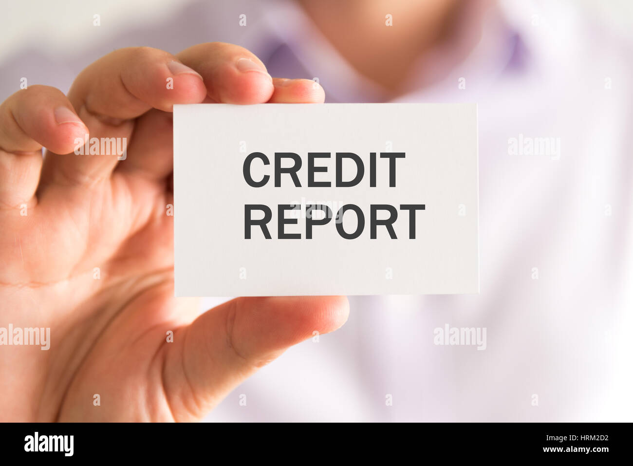 Closeup on businessman holding a card with CREDIT REPORT message, business concept image with soft focus background Stock Photo