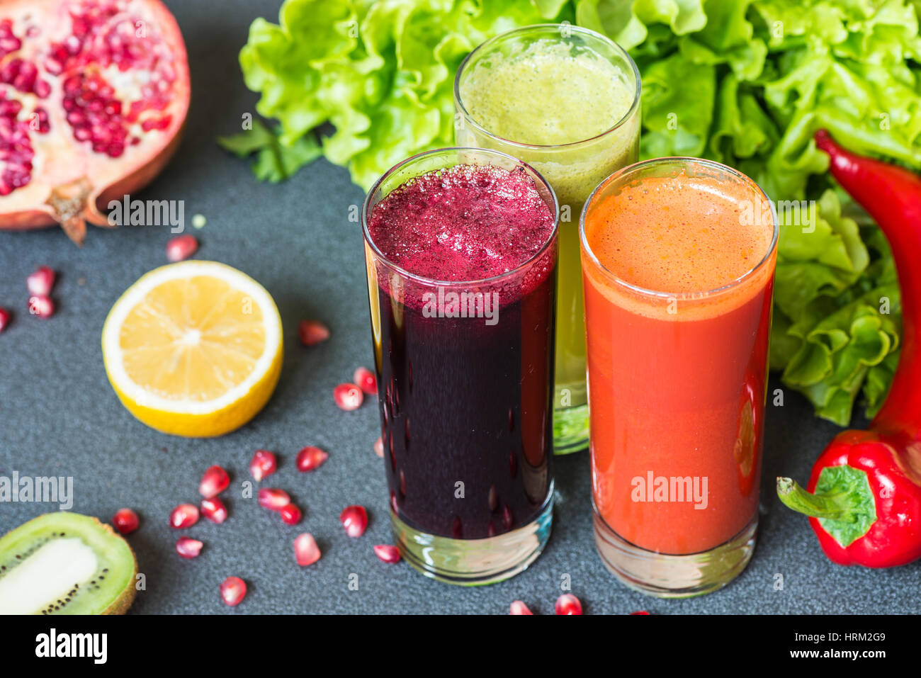 three glasses of different fresh juice. Beet, carrot and kiwi ...