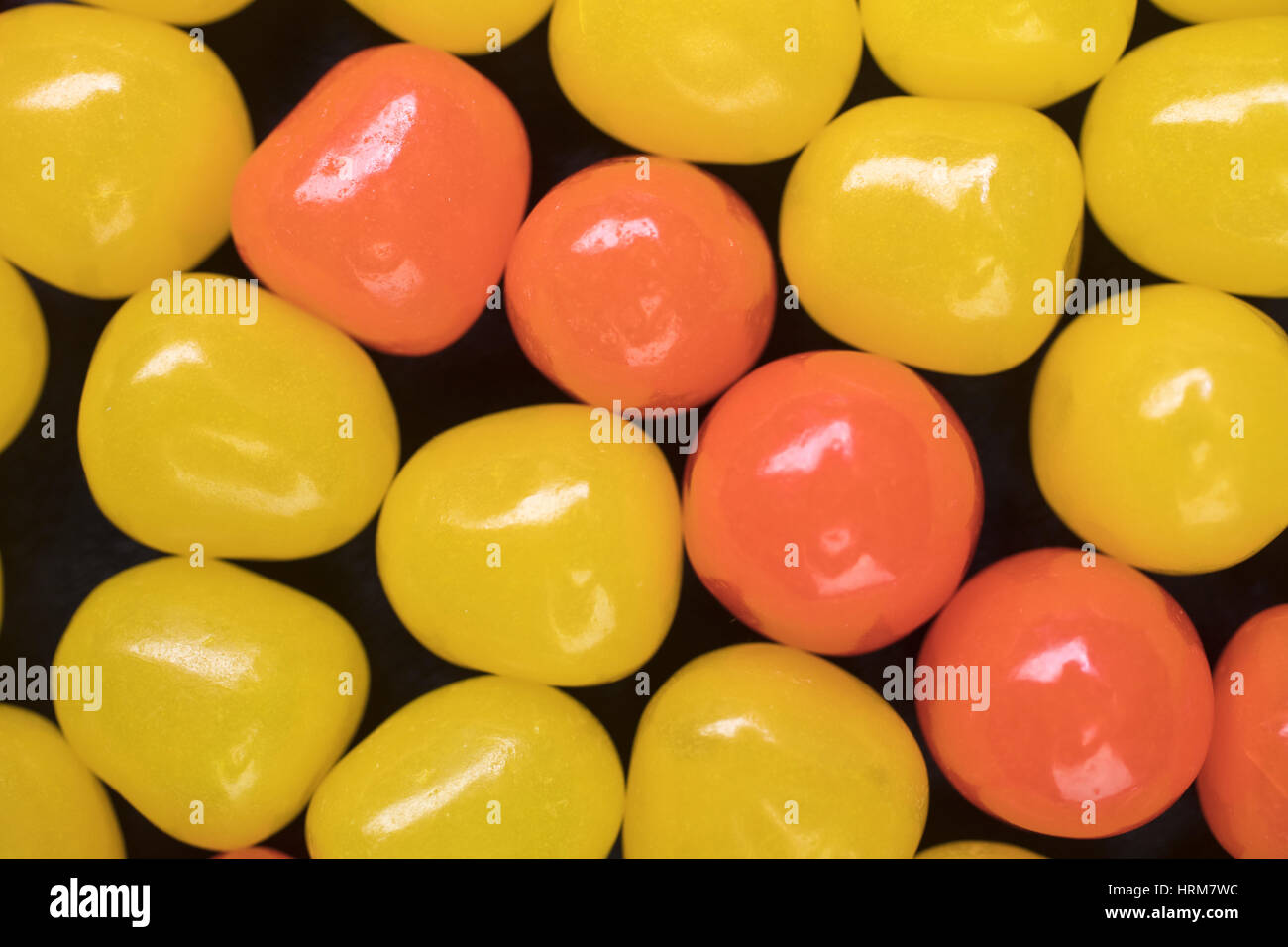 Yellow and Orange Candy Sour Balls creating a design background Stock