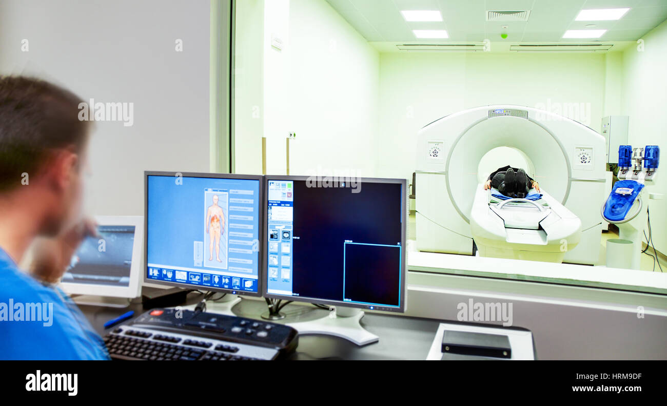 A patient being scanned with MRI xray scanner in modern hitech