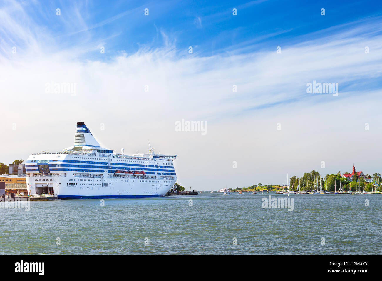 Cargo-passenger cruise ferry moored in Bay at pier in Helsinki port. Waiting for passengers boarding from terminal and loading of vehicles and cargo.  Stock Photo