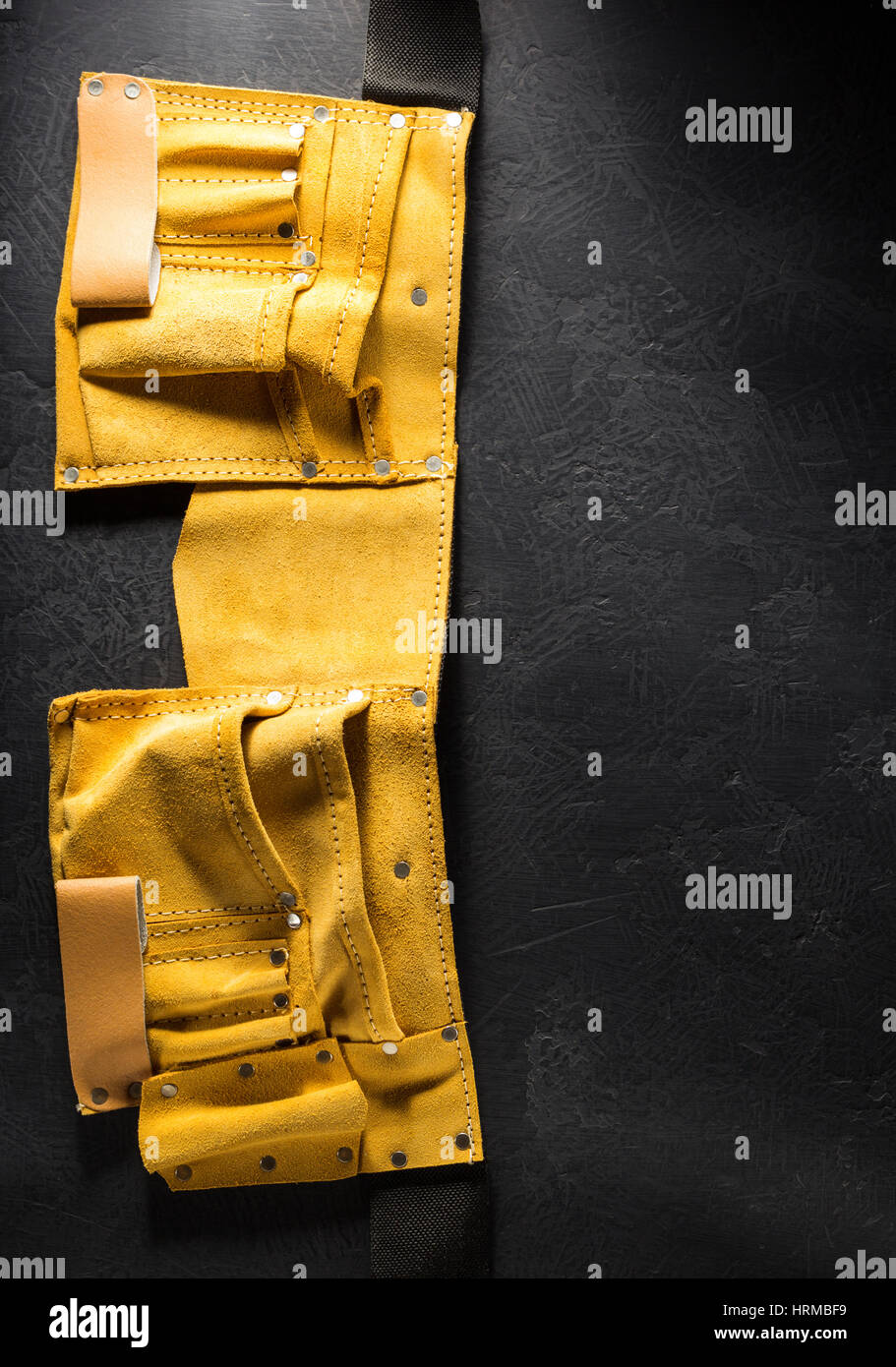 Tool belt on black background Stock Photo - Alamy