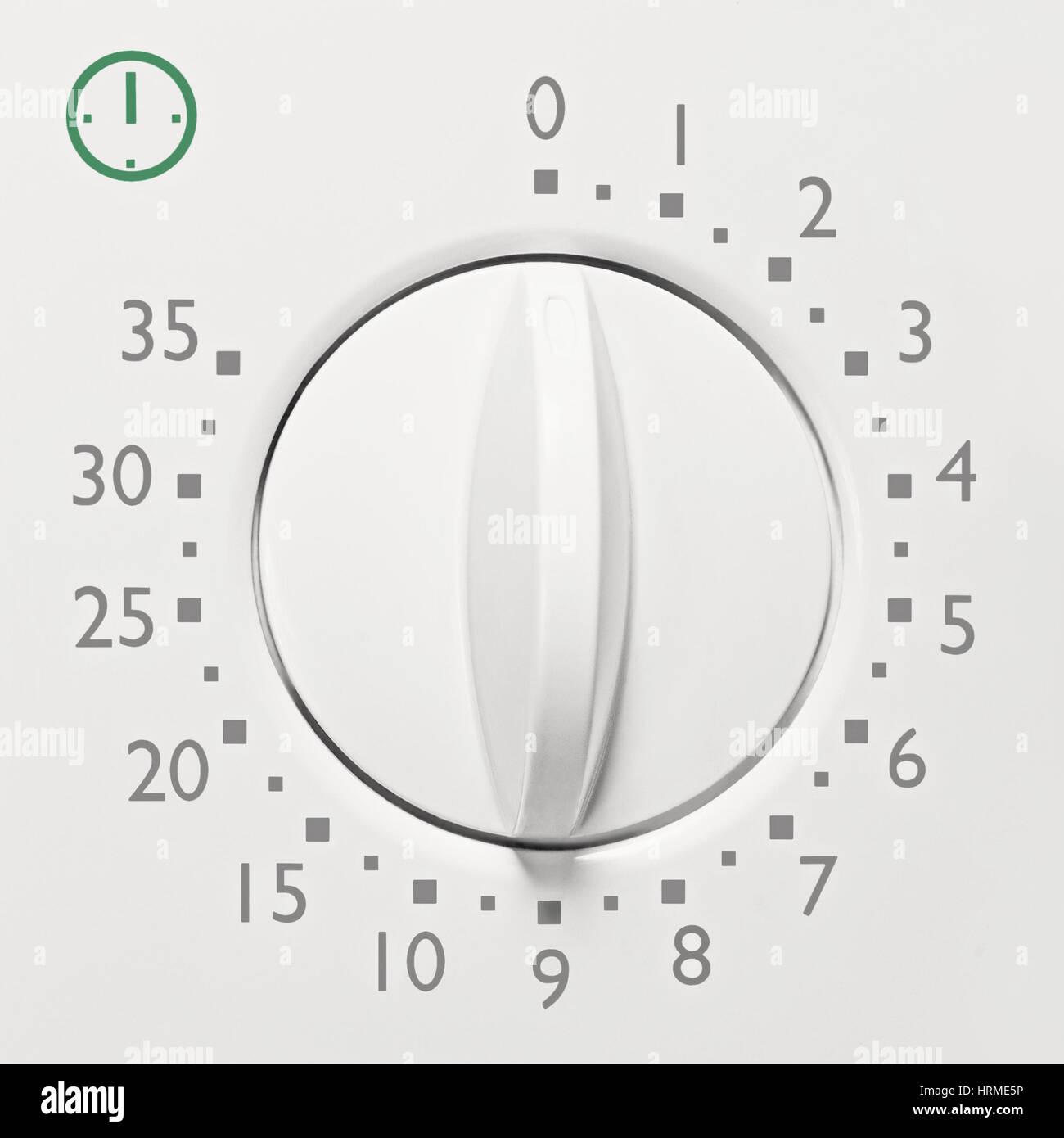 Analog 35 minute microwave oven timer, analogue vintage white dial face macro closeup, grey numbers, green icon, large background copy space horizonta Stock Photo