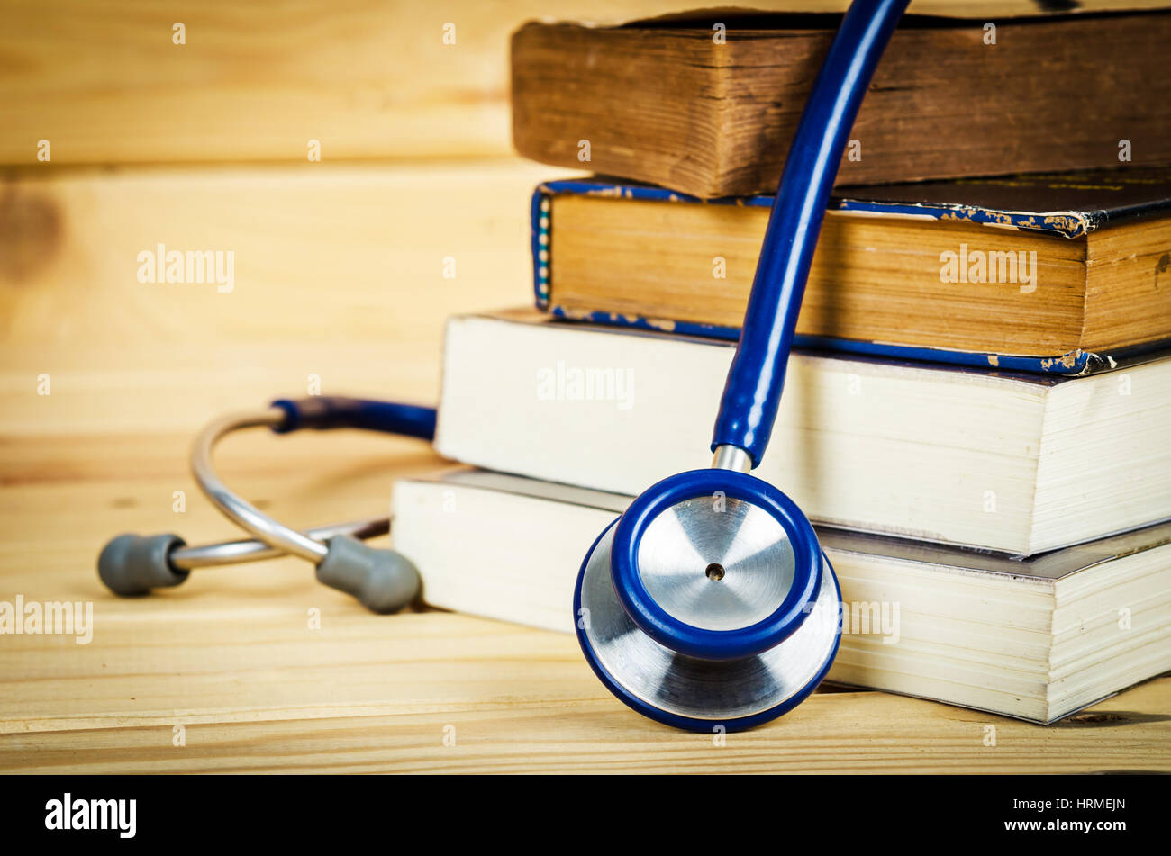 Stethoscope and old books on wooden background Stock Photo - Alamy