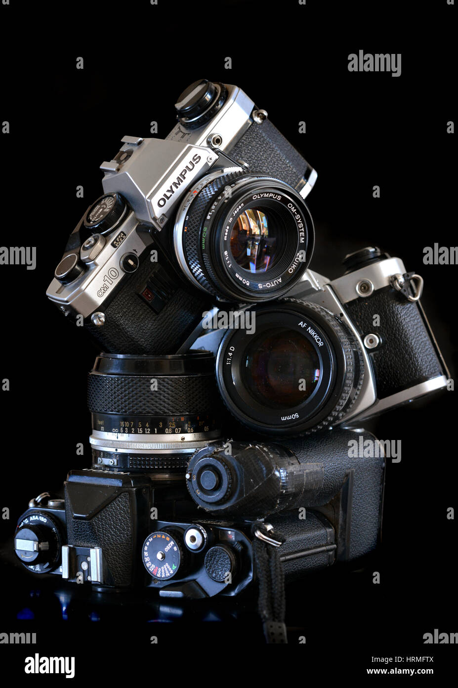 Pile of old retro film cameras - Nikon, Olympus Stock Photo