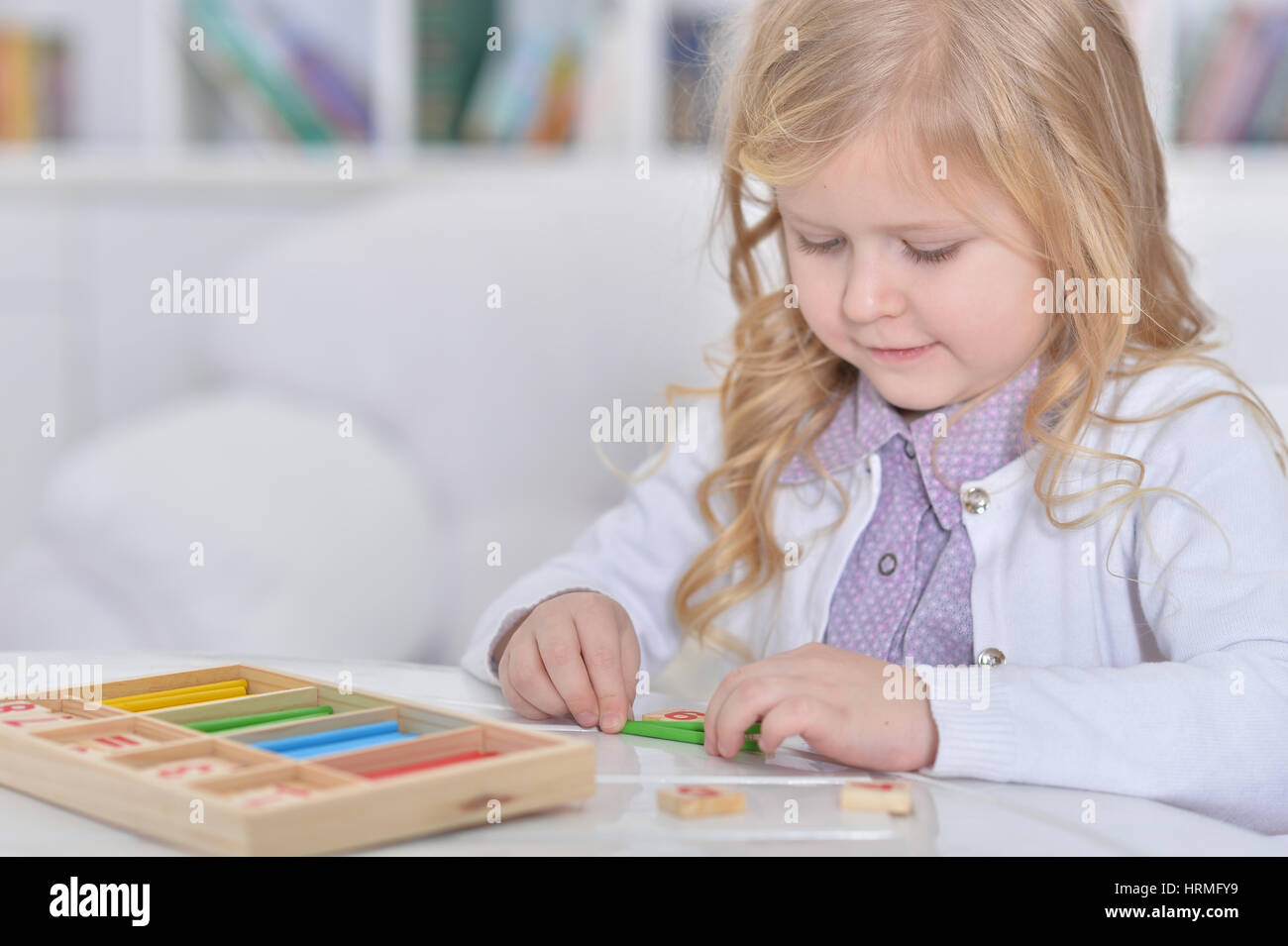 cute little girl playing with educational toy Stock Photo - Alamy