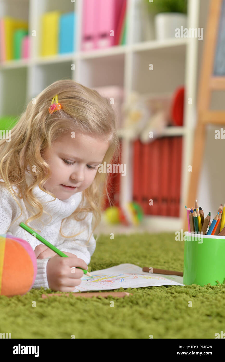 cute little girl drawing, lying on the floor Stock Photo - Alamy
