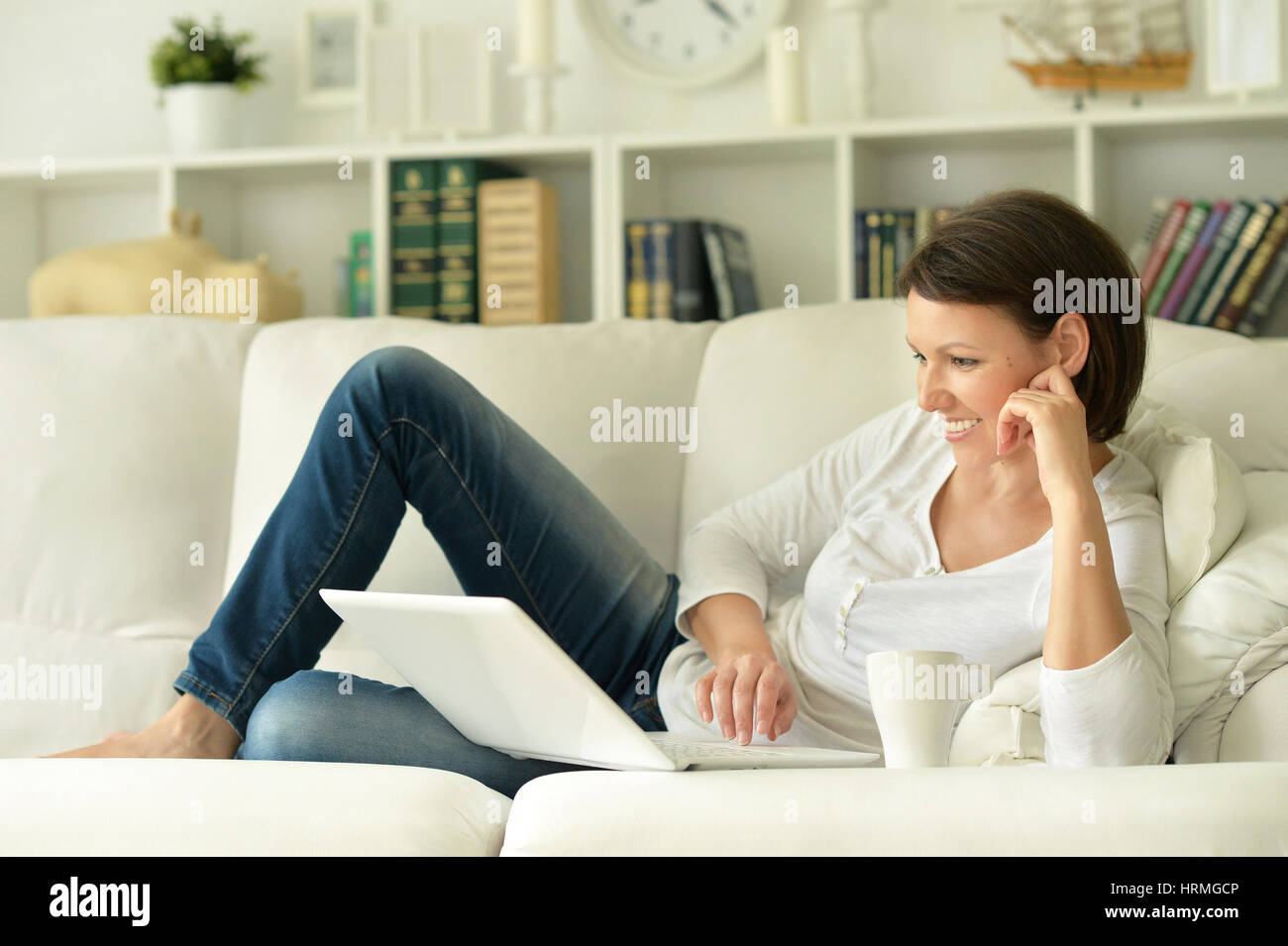 young brunette woman using laptop at home Stock Photo - Alamy