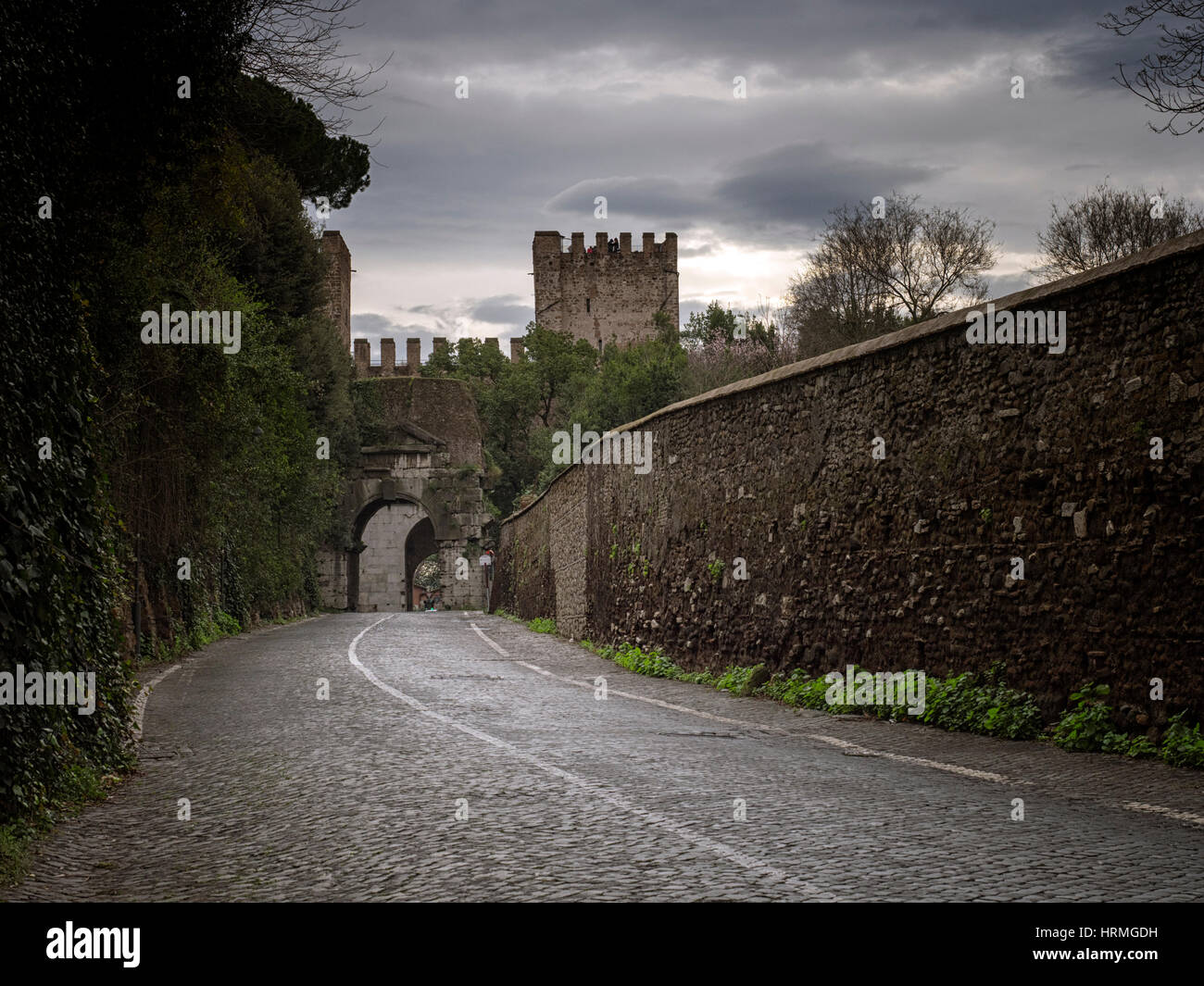 Via San Sebastiano towards the gate in the old Aurelian Walls in Rome, Italy Stock Photo