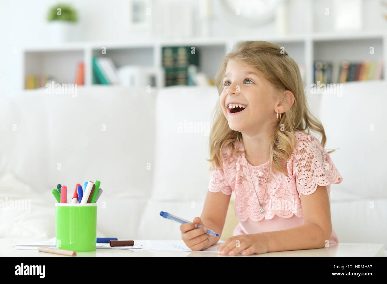 Portrait of a cute little girl drawing with markers Stock Photo - Alamy