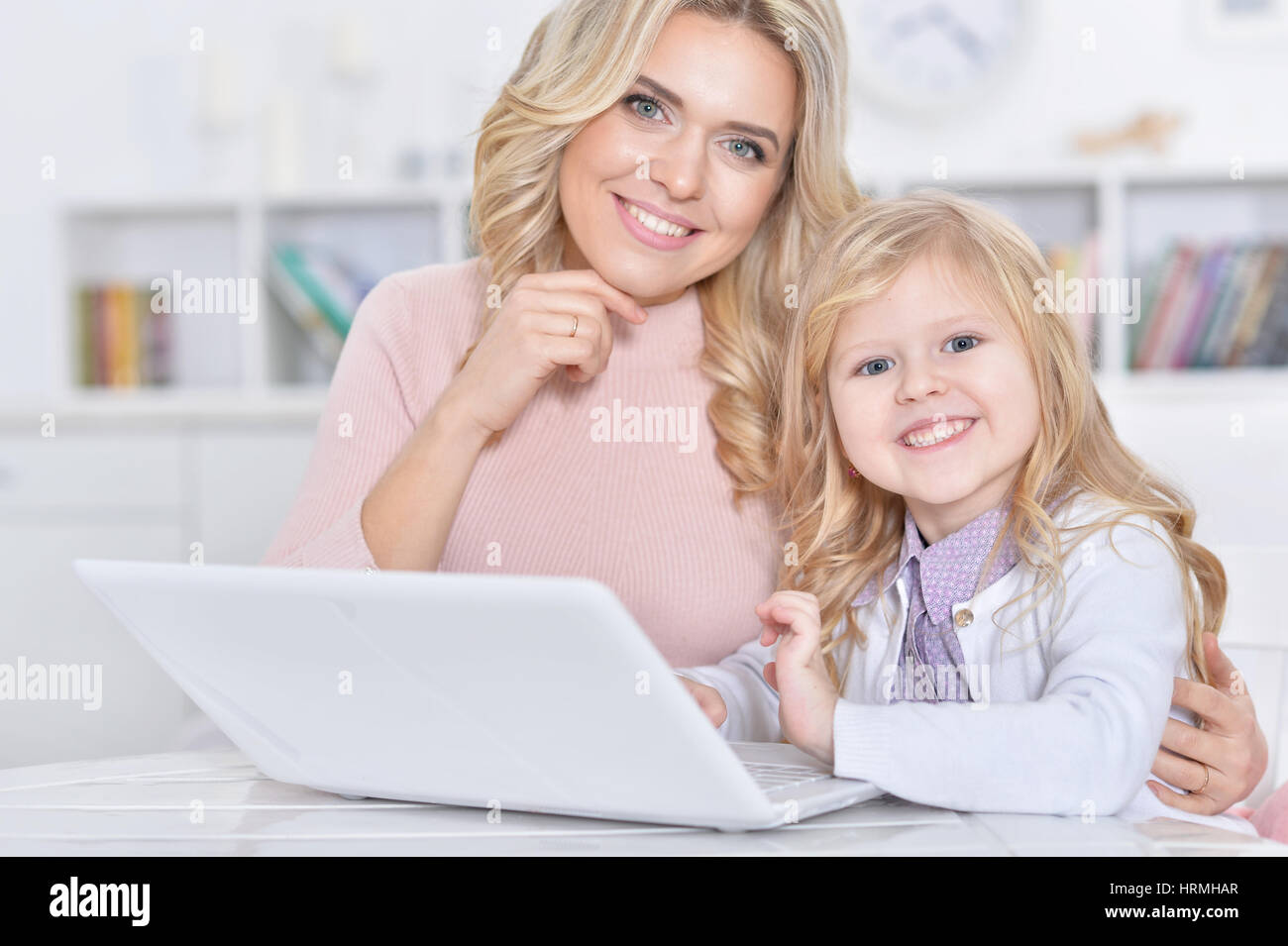 young woman and little girl using laptop Stock Photo - Alamy