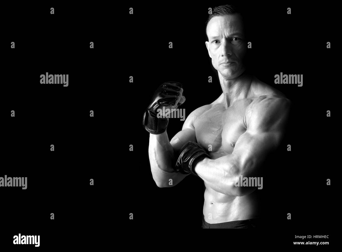 Strong Mixed Martial Arts fighter isolated in black Stock Photo Alamy