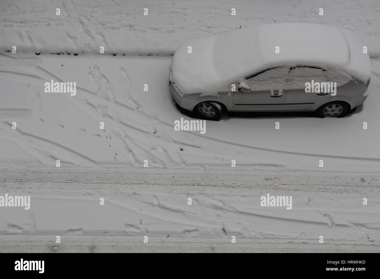 A car parked on the road during the snowy season Stock Photo - Alamy