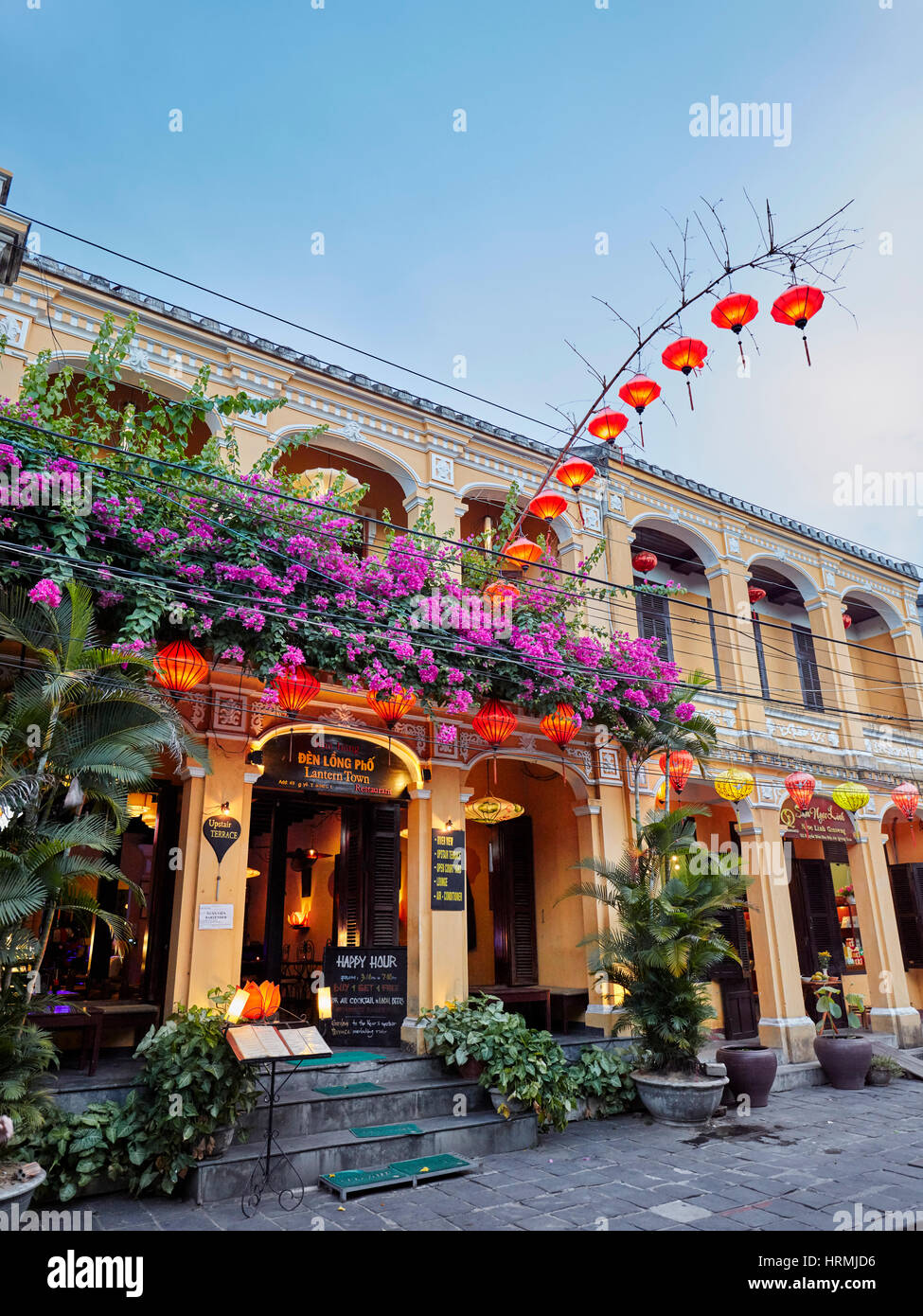 Old building with garland of lanterns in Hoi An Ancient Town. Hoi An, Quang Nam Province, Vietnam. Stock Photo