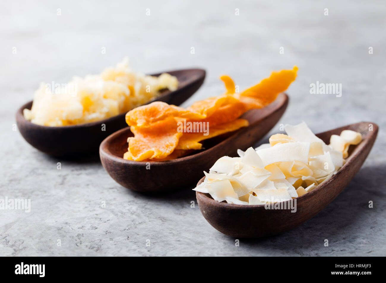 Healthy snacks. Dried mango, coconut chips and palm sugar in wooden