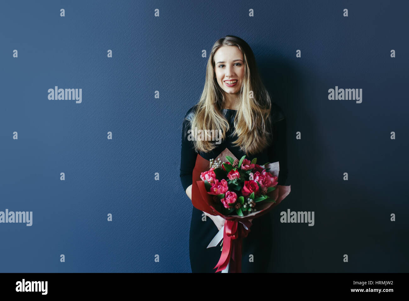 Girlfriend with bouquet of red tulips. Studio. Stock Photo