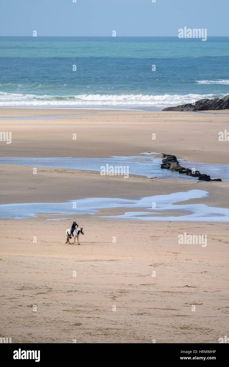 horse rider distance riding Crantock Beach Newquay Cornwall UK Stock