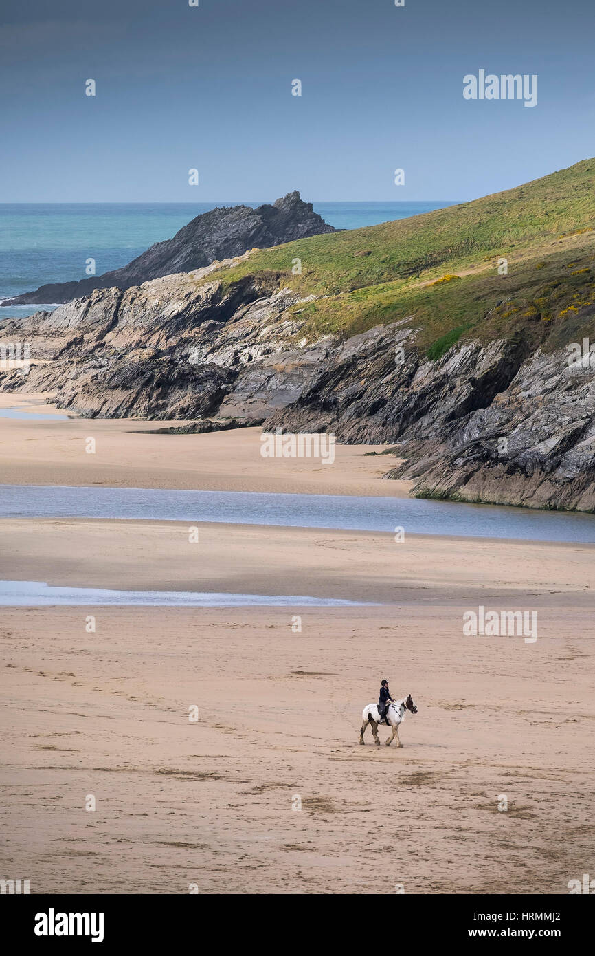 horse rider distance riding Crantock Beach Newquay Cornwall UK Stock Photo