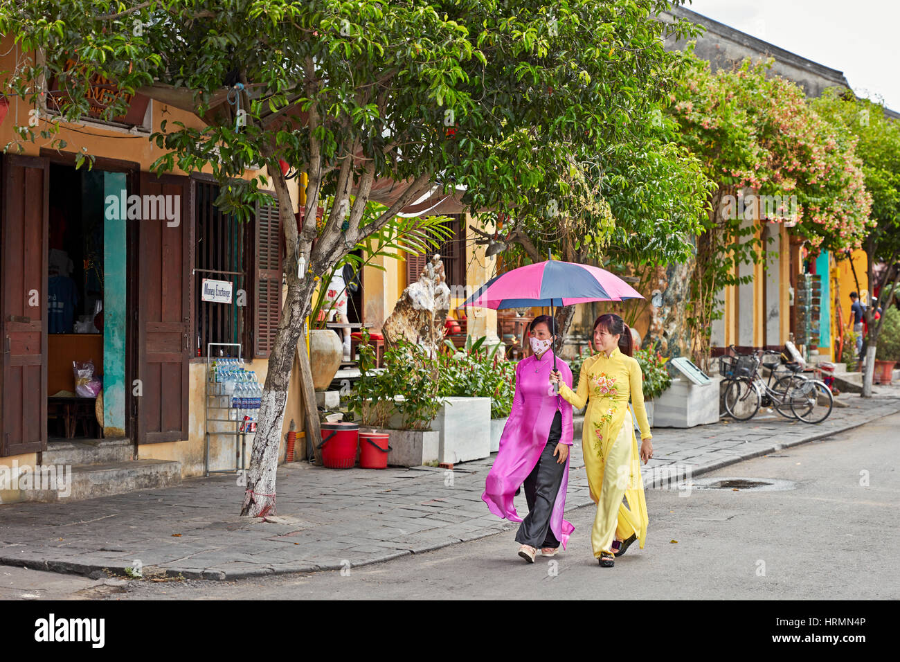 Women wearing traditional Vietnamese Ao Dai dress. Hoi An Ancient Town, Quang Nam Province, Vietnam. Stock Photo
