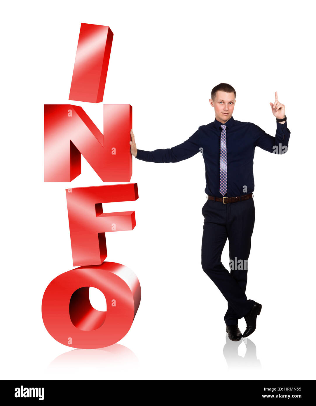 Young businessman stands in free pose next to letters INFO and is ready to answer your question, isolated on white background. Your support. He points Stock Photo