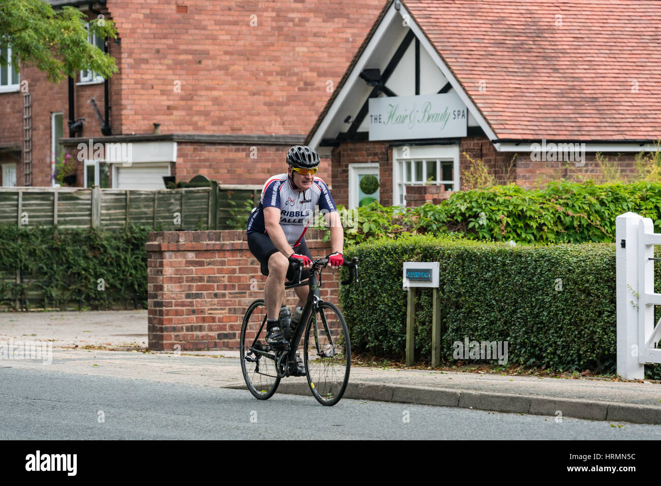 Cyclist in the Rise Above sportive riding through Pulford near Chester Stock Photo