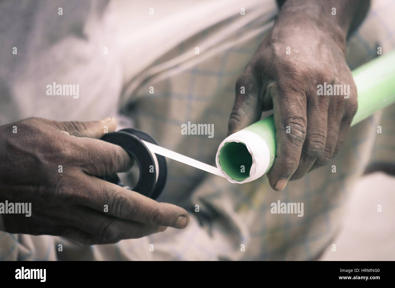 Plumber wrapping tread tape in PVC pipe Stock Photo Alamy