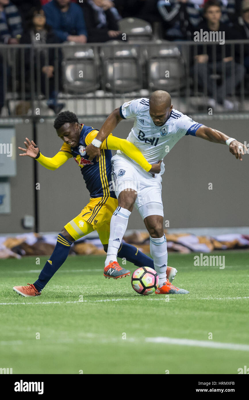 Vancouver, Canada. 2 March, 2017. Kendall Waston (4) of Vancouver Whitecaps and Derrick Etienne (7) of New York Red Bulls fighting to get the ball. Concacaf Championship League 2016/17 Quarter Finals between Vancouver Whitecaps and New York Red Bulls, BC Place. Vancouver defeats New York 2-0, and advances to the semi-finals.© Gerry Rousseau/Alamy Live News Stock Photo