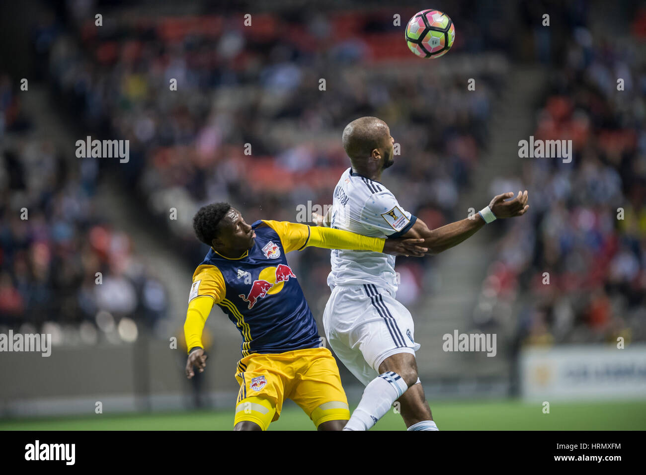 Vancouver, Canada. 2 March, 2017. Kendall Waston (4) of Vancouver Whitecaps, and Derrick Etienne (7) of New York Red Bulls in action for the ball. Concacaf Championship League 2016/17 Quarter Finals between Vancouver Whitecaps and New York Red Bulls, BC Place. Vancouver defeats New York 2-0, and advances to the semi-finals.© Gerry Rousseau/Alamy Live News Stock Photo