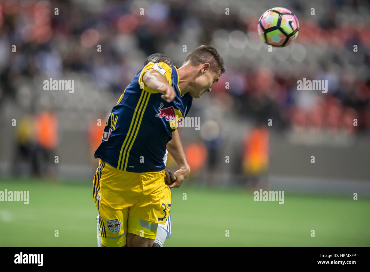 Vancouver, Canada. 2 March, 2017. Aaron Long (33) of New York Red Bulls, heading the ball. Concacaf Championship League 2016/17 Quarter Finals between Vancouver Whitecaps and New York Red Bulls, BC Place. Vancouver defeats New York 2-0, and advances to the semi-finals.© Gerry Rousseau/Alamy Live News Stock Photo