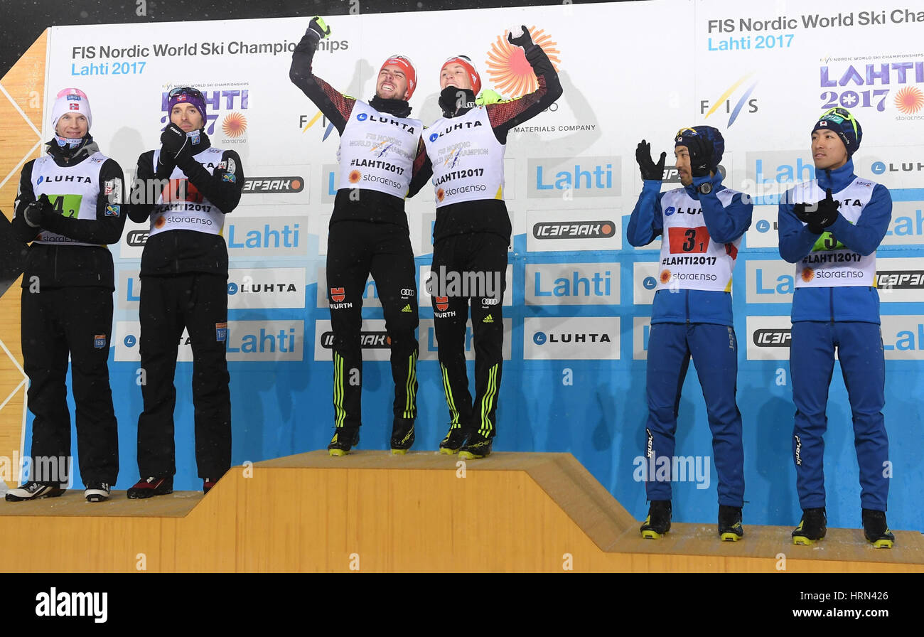 Lahti, Finland. 3rd Mar, 2017. Johannes Rydzek (center l) and Eric Frenzel from Germany celebrate their victory after the team sprint of the combination large hill/2 x 7.5 km team sprint event at the Nordic Ski World Championship in Lahti, Finland, 3 March 2017. The Norwegian team with Magnus Moan (l) and Magnus Krog (silver) and the Japanese team with Yoshito Watabe and Akito Watabe (r) also stand on the podium during the presentation ceremony. Photo: Hendrik Schmidt/dpa-Zentralbild/dpa/Alamy Live News Stock Photo