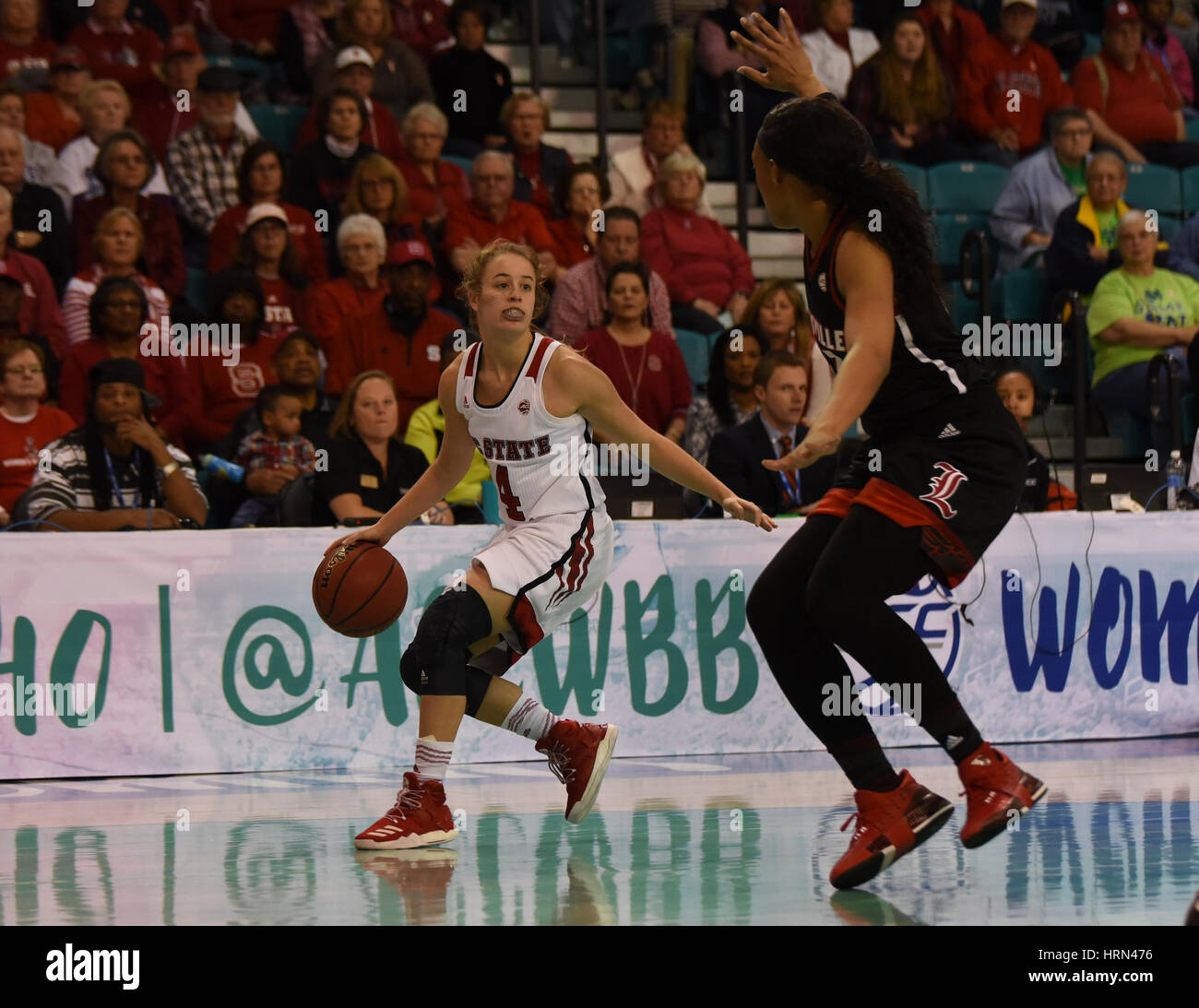 Conway, South Carolina, USA. 3rd Mar, 2017. North Carolina State Wolfpack guard Ashley Williams (4) looks for an open teammate during the game between the Louisville Cardinals and the North Carolina State Wolfpack in the ACC Women's Tournament on March 3, 2017 at HTC Center in Conway, SC. Lousiville defeated NC State 59-58. William Howard/CSM Credit: Cal Sport Media/Alamy Live News Stock Photo