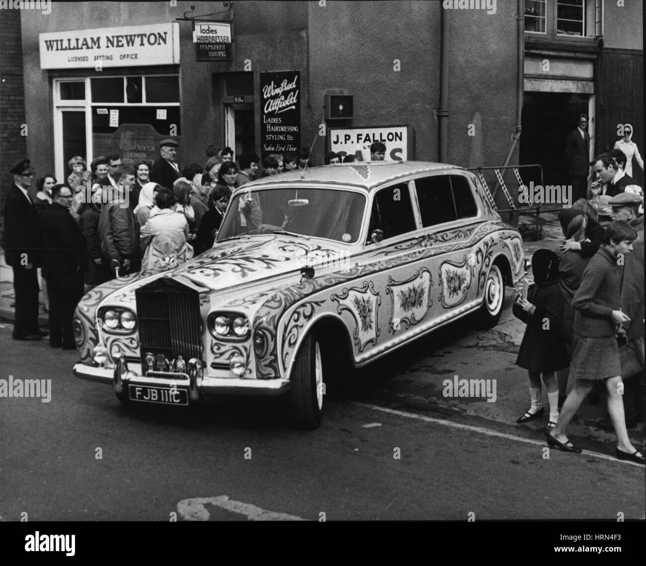 May 05, 1967 - John Lennon's decorated Rolls Royce: Beatle John lennon yesterday took delivery of his re-decorated Rolls Yesterday. It has been painted yellow, with signs of the zodiac and bunches of flowers in red, green and blue on the roof and the doors. The wheels are in red, white, blue and orange. Photo shows John Lennon's decorated Rolls Royce, pictured in Chertsey, Surrey, yesterday. (Credit Image: © Keystone Press Agency/Keystone USA via ZUMAPRESS.com) Stock Photo