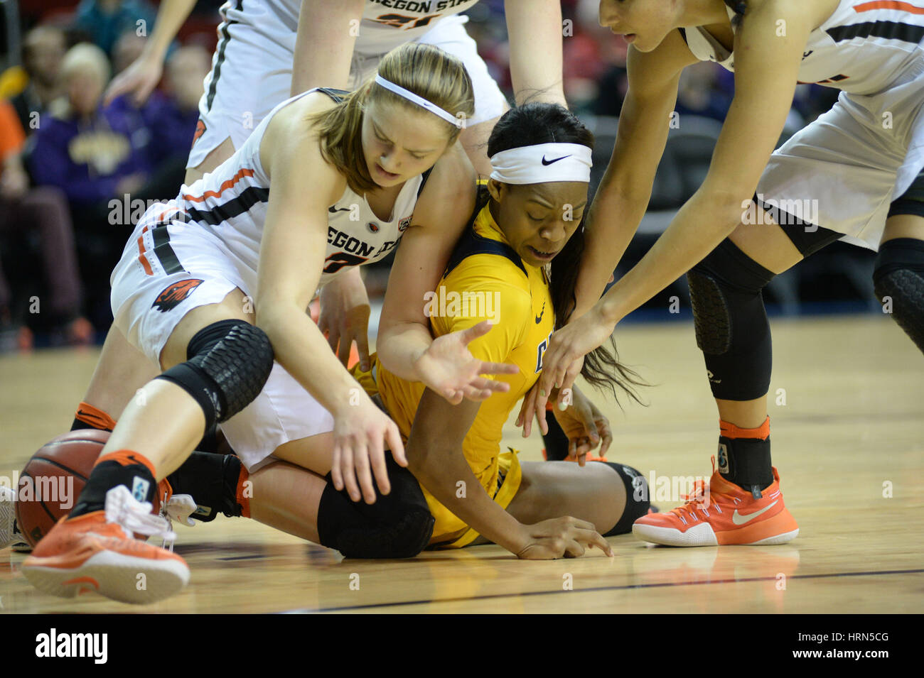 Seattle, WA, USA. 3rd Mar, 2017. OSU's Mikayla Pivec (0) and Cal's Ki'Cole Cayton (21) scramble for a loose ball during a PAC12 women's tournament game between the Oregon State Beavers and the Cal Bears. The game was played at Key Arena in Seattle, WA. Jeff Halstead/CSM/Alamy Live News Stock Photo