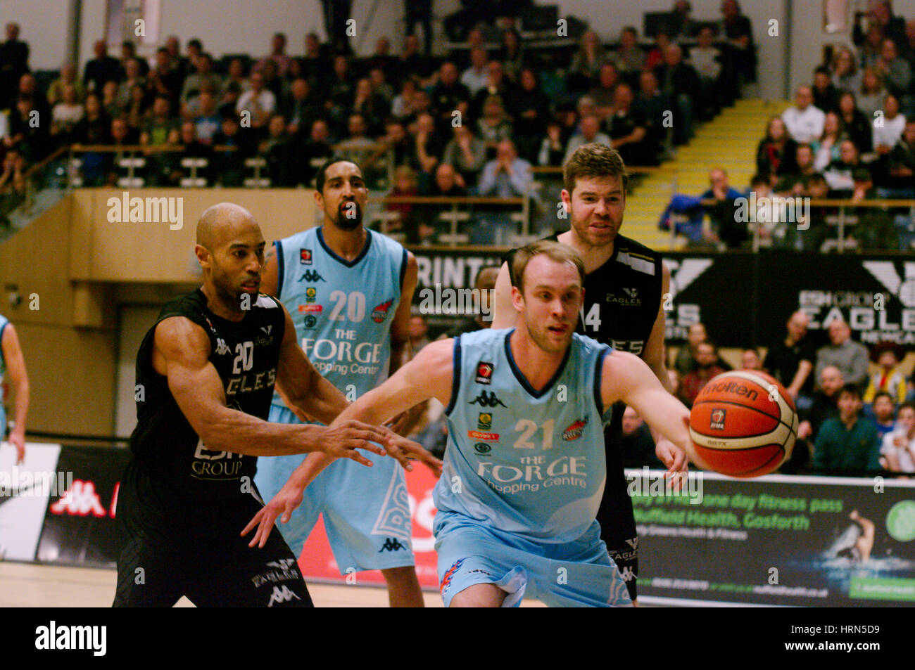 Newcastle upon Tyne,England, 3rd March 2017. Lewis Thomas, number 21, of Glasgow Rocks passing the ball during the match against Esh Group Eagles Newcastle in the British Basketball League match at Sport Central. Watching are Fabulous Flournoy, Kieron Achara and Scott Martin. Credit: Colin Edwards/Alamy Live News Stock Photo