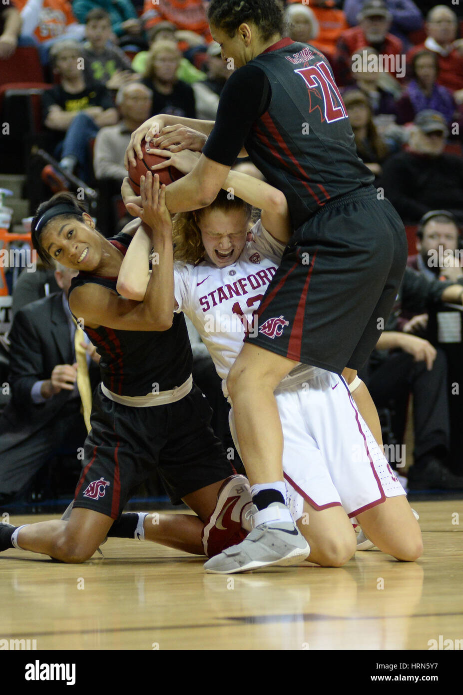 Seattle, WA, USA. 3rd Mar, 2017. Stanford guard Brittany McPhee (12) is tied up by WSU's Nike McClure (21) and Caila Hailey (1) during a PAC12 women's tournament game between the Washington State Cougars and the Stanford Cardinal. The game was played at Key Arena in Seattle, WA. Jeff Halstead/CSM/Alamy Live News Stock Photo