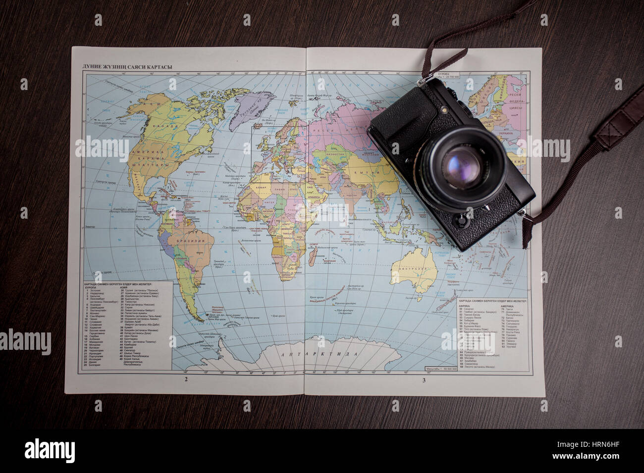 The camera lies on the world map Stock Photo